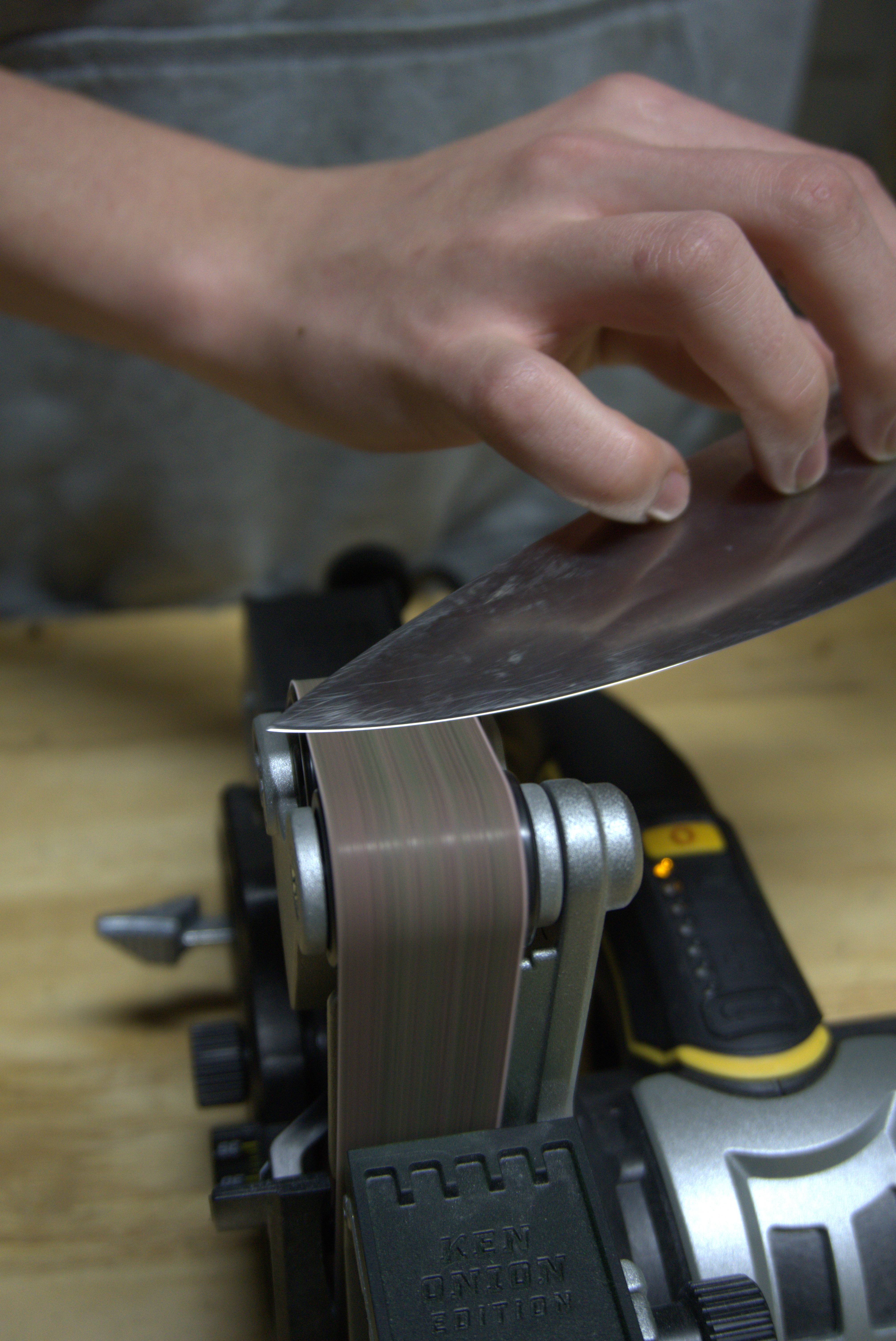 Professional knife sharpening on belt grinder